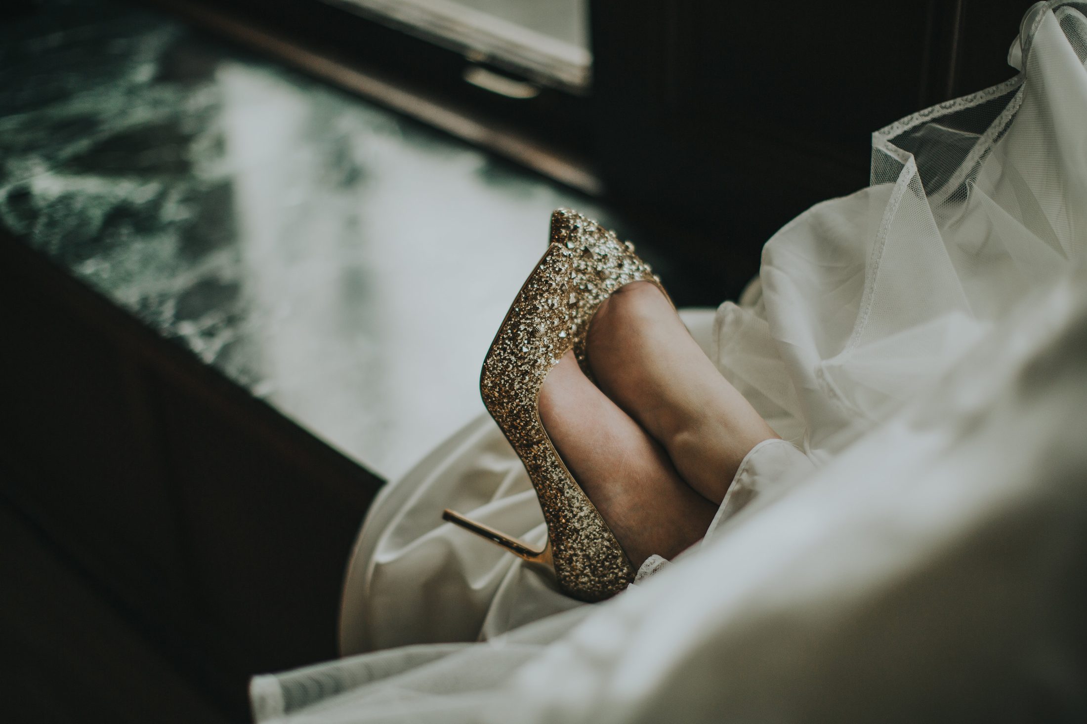Bridal shoe and gown detail.
